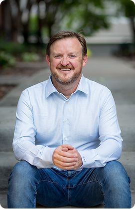 Dr. Brandon Baldwin smiling in office